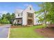 Stunning two-story modern farmhouse with metal roof and manicured lawn on a sunny day at 12520 Celestine Way, Milton, GA 30075