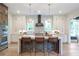 Eat in kitchen with large island, stone tile backsplash, and stainless steel appliances at 12520 Celestine Way, Milton, GA 30075