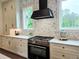 Gourmet kitchen features stainless steel appliances, custom cabinets, and stone backsplash at 12520 Celestine Way, Milton, GA 30075