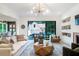 Open concept living room with a modern fireplace, recessed shelves, and access to the patio at 12520 Celestine Way, Milton, GA 30075
