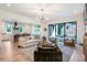 Bright and airy living room open to the kitchen, featuring stylish furniture and a sliding glass door to the yard at 12520 Celestine Way, Milton, GA 30075