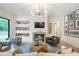 Bright and airy living room features a fireplace, large windows, and recessed shelving at 12520 Celestine Way, Milton, GA 30075