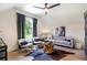 Chic living room featuring a unique wood coffee table, comfortable seating, and a serene outdoor view at 12520 Celestine Way, Milton, GA 30075