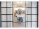 Stylish home office featuring built-in cabinets and a comfortable workspace behind sophisticated glass doors at 12520 Celestine Way, Milton, GA 30075