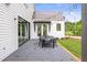 Stylish patio with an outdoor dining set and string lights, ideal for al fresco meals at 12520 Celestine Way, Milton, GA 30075