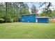 View of house from spacious backyard with lush lawn, privacy fence, and surrounding mature trees at 3003 Butler Creek Nw Rd, Kennesaw, GA 30152