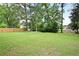 Expansive backyard featuring lush lawn, privacy fence, and mature trees for outdoor enjoyment at 3003 Butler Creek Nw Rd, Kennesaw, GA 30152