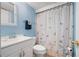 This is a bathroom featuring a shower with butterfly curtain at 3003 Butler Creek Nw Rd, Kennesaw, GA 30152