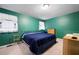 Green bedroom with natural light and blue comforter at 3003 Butler Creek Nw Rd, Kennesaw, GA 30152