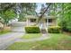 Inviting home with a manicured lawn, featuring bright blue shutters and a cozy front porch at 3003 Butler Creek Nw Rd, Kennesaw, GA 30152