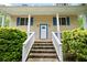 Charming front porch with brick stairs, white railings, and bright blue shutters, perfect for relaxing at 3003 Butler Creek Nw Rd, Kennesaw, GA 30152