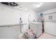 Bright laundry room with washer, dryer, ironing board and storage; making laundry tasks easier at 3003 Butler Creek Nw Rd, Kennesaw, GA 30152