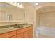Bathroom with a vanity, granite countertop, large mirror, and tub with shower at 3445 Stratford Ne Rd # 305, Atlanta, GA 30326