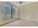Cozy bedroom featuring neutral carpet, a ceiling fan, and a large window at 3445 Stratford Ne Rd # 305, Atlanta, GA 30326