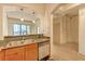 View of kitchen featuring wood cabinets, granite counters, sink, and dishwasher at 3445 Stratford Ne Rd # 305, Atlanta, GA 30326