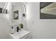 Modern bathroom with stylish vanity, sleek black faucet, and contemporary wall sconces at 3634 Oakleaf Pass, Fairburn, GA 30213