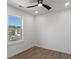 Bright bedroom features a ceiling fan, natural light, and hardwood floors at 3634 Oakleaf Pass, Fairburn, GA 30213
