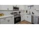 Modern kitchen boasts stainless steel appliances, white cabinetry, and a sleek countertop at 3634 Oakleaf Pass, Fairburn, GA 30213