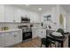 Stylish kitchen featuring stainless steel appliances, white cabinetry, and contemporary finishes at 3634 Oakleaf Pass, Fairburn, GA 30213
