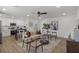 Sun-filled living room featuring modern decor, a ceiling fan, and an open layout to the kitchen at 3634 Oakleaf Pass, Fairburn, GA 30213
