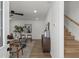 Cozy living room featuring a ceiling fan, hardwood floors, and an easy access to the staircase at 3634 Oakleaf Pass, Fairburn, GA 30213