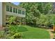 Backyard view featuring a lush green lawn and the home's screened-in porch at 4058 Vinings Mill Se Trl, Smyrna, GA 30080