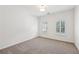 Bright bedroom featuring carpeted floors, two windows, neutral walls, and bright lighting at 4058 Vinings Mill Se Trl, Smyrna, GA 30080