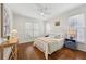 Bedroom with hardwood floors, a ceiling fan, and three large windows for natural light at 4058 Vinings Mill Se Trl, Smyrna, GA 30080