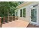 A charming outdoor deck area with wood floors adjoins the home and overlooks a wooded area at 4058 Vinings Mill Se Trl, Smyrna, GA 30080