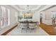 Bright dining room featuring wainscoting, hardwood floors, and natural light from large windows at 4058 Vinings Mill Se Trl, Smyrna, GA 30080
