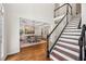 Inviting entryway with hardwood floors, staircase, and view into the formal dining room at 4058 Vinings Mill Se Trl, Smyrna, GA 30080