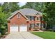 Charming two-story brick home with a well-manicured lawn and a two-car garage at 4058 Vinings Mill Se Trl, Smyrna, GA 30080