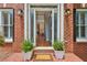 Elegant front entryway featuring a brick porch and beautiful glass paneled doors at 4058 Vinings Mill Se Trl, Smyrna, GA 30080