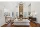 Bright living room with a grand fireplace, hardwood floors, and a soaring ceiling at 4058 Vinings Mill Se Trl, Smyrna, GA 30080