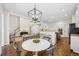 Bright open concept living space with hardwood floors, a modern light fixture, and a bar counter with seating at 4058 Vinings Mill Se Trl, Smyrna, GA 30080