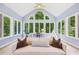This bright sunroom offers wooded views from the many windows, a vaulted ceiling, and comfortable seating at 4058 Vinings Mill Se Trl, Smyrna, GA 30080
