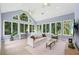 Inviting sunroom with high ceilings, large windows offering beautiful wooded views, and comfortable seating at 4058 Vinings Mill Se Trl, Smyrna, GA 30080