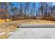 Large backyard with a wooden fence and a small storage shed at 5109 Dogwood Hills Dr, Sugar Hill, GA 30518