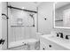 White bathroom features shower with sliding glass doors, sleek fixtures, and vanity at 5109 Dogwood Hills Dr, Sugar Hill, GA 30518