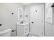 White bathroom features sleek fixtures, recessed lighting, and vanity at 5109 Dogwood Hills Dr, Sugar Hill, GA 30518