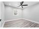 Bedroom with neutral walls, a ceiling fan, a window, recessed lighting, and gray wood-look flooring at 5109 Dogwood Hills Dr, Sugar Hill, GA 30518