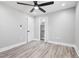 Bedroom featuring a ceiling fan, neutral walls, a closet with shelving, and gray wood-look flooring at 5109 Dogwood Hills Dr, Sugar Hill, GA 30518