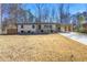 Charming ranch-style home with a white exterior and a well-maintained front yard landscape at 5109 Dogwood Hills Dr, Sugar Hill, GA 30518