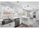 Bright kitchen features a large stainless sink and stainless steel appliances at 5109 Dogwood Hills Dr, Sugar Hill, GA 30518