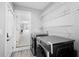 Convenient laundry room includes a washer and dryer and a view into the kitchen at 5109 Dogwood Hills Dr, Sugar Hill, GA 30518