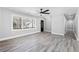 Well-lit living room with gray walls, modern lighting, and large windows at 5109 Dogwood Hills Dr, Sugar Hill, GA 30518