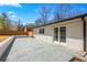 A spacious stone patio outside of this home with sliding glass doors at 5109 Dogwood Hills Dr, Sugar Hill, GA 30518