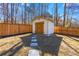 Backyard shed with wooden doors and stepping stone walkway at 5109 Dogwood Hills Dr, Sugar Hill, GA 30518