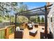 Inviting back deck with a pergola, comfortable seating, and a fire pit for outdoor entertaining at 3013 Surrey Ln, Atlanta, GA 30341