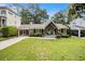 Charming home exterior with a well-maintained lawn, inviting entryway, and convenient carport at 3013 Surrey Ln, Atlanta, GA 30341